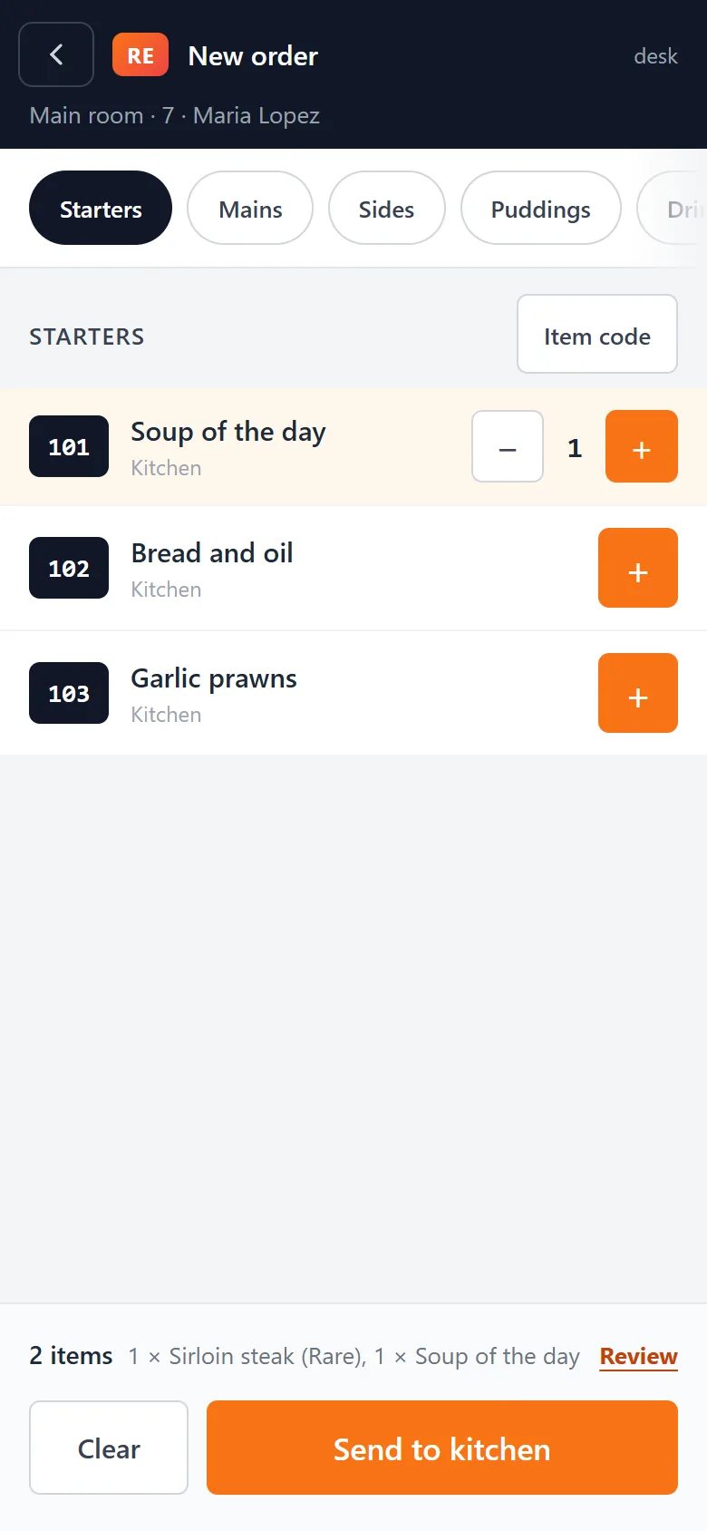 The menu on a phone with the starters listed, and two dishes waiting to be sent to the kitchen.